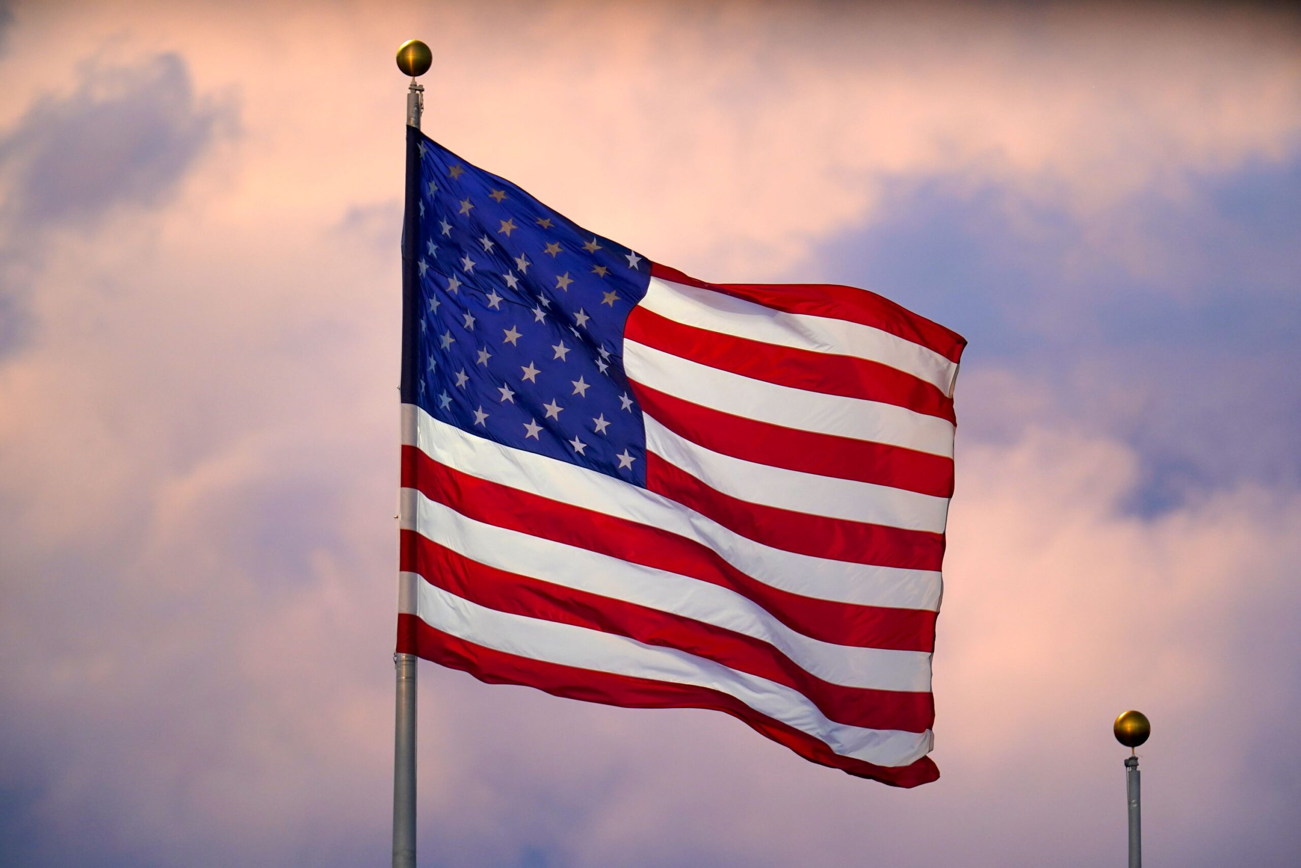 American flag flying against an evening sky